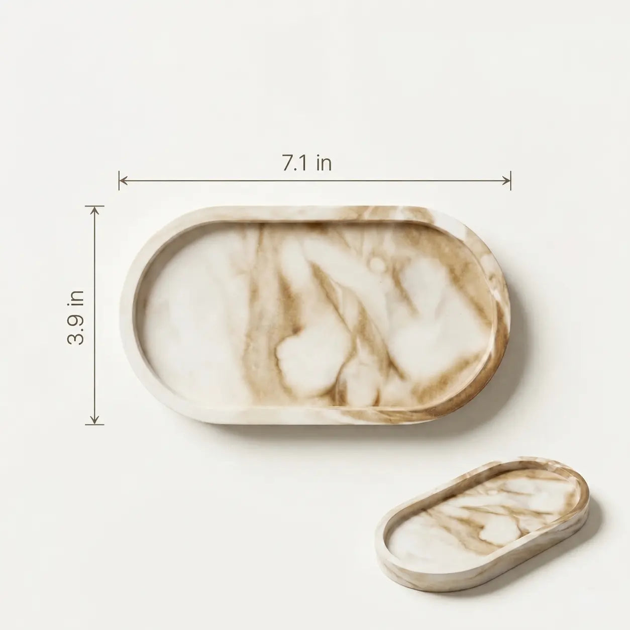 Size guide for oval marble-look vanity tray measuring 7.1 inches by 3.9 inches