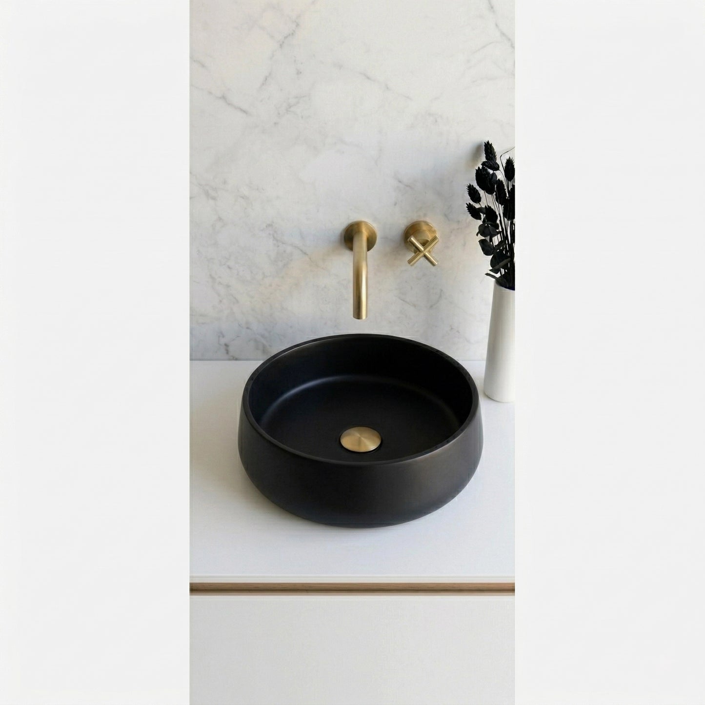 Round black concrete stone vessel sink on modern minimalist bathroom vanity with brass faucet