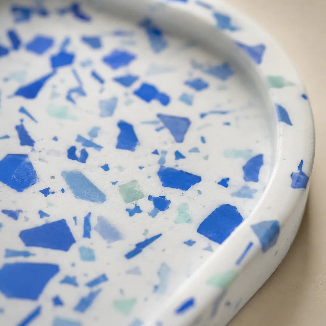 Close up of blue terrazzo tray surface with white base and blue chips