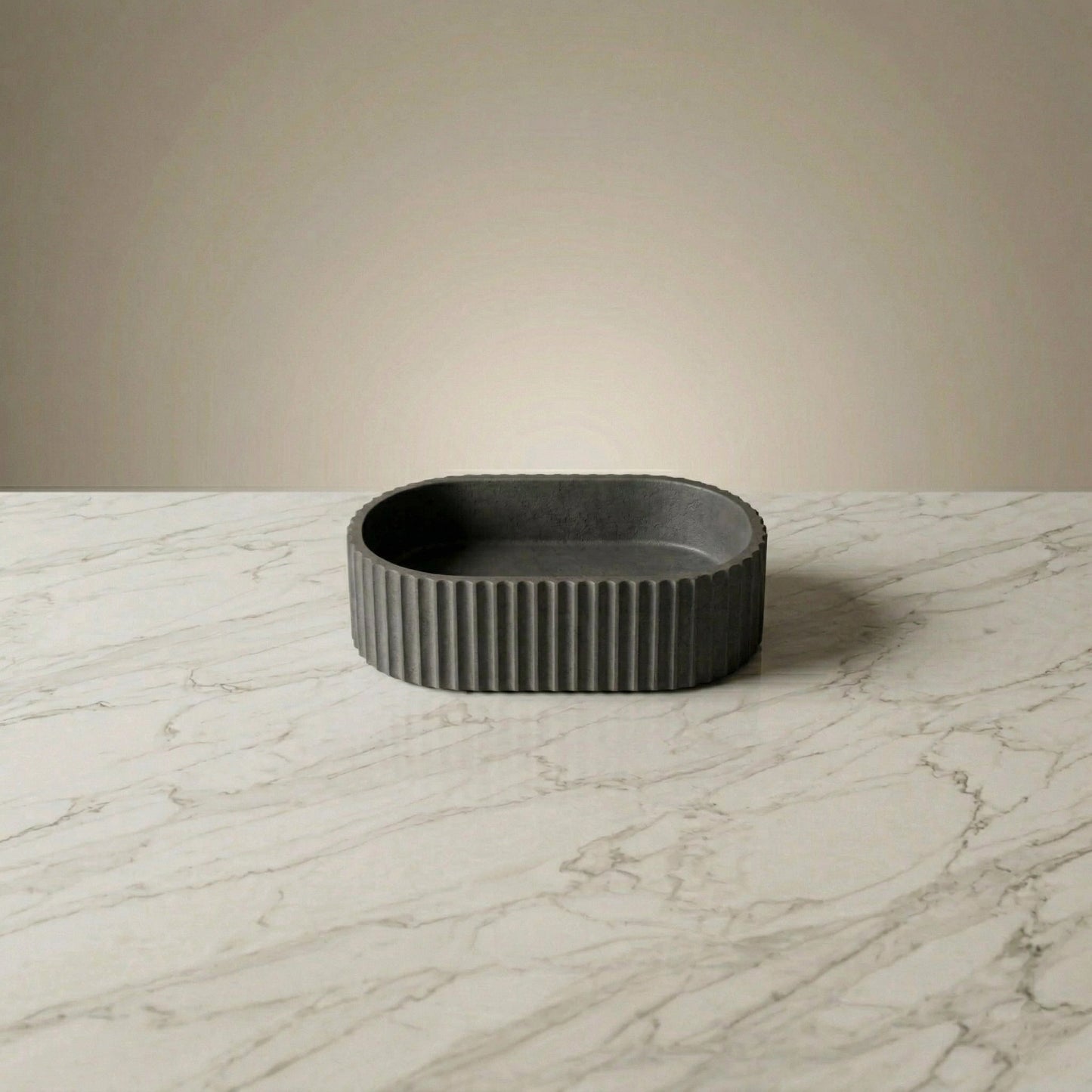 Charcoal fluted oval vessel sink on marble countertop, modern dark gray stone vessel sink for contemporary bathroom