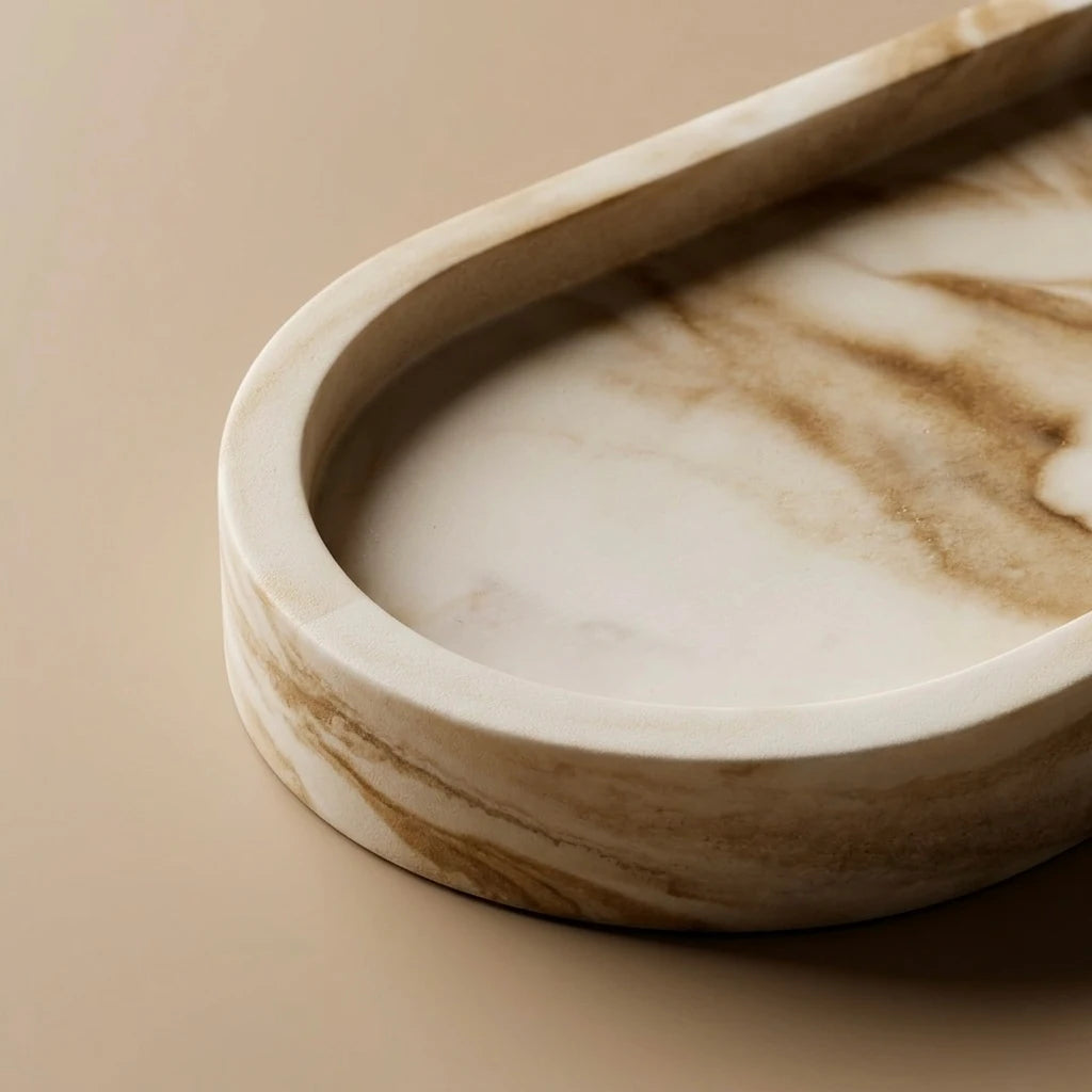 Close-up of cream beige marble-look tray with raised rim and stone-inspired veining