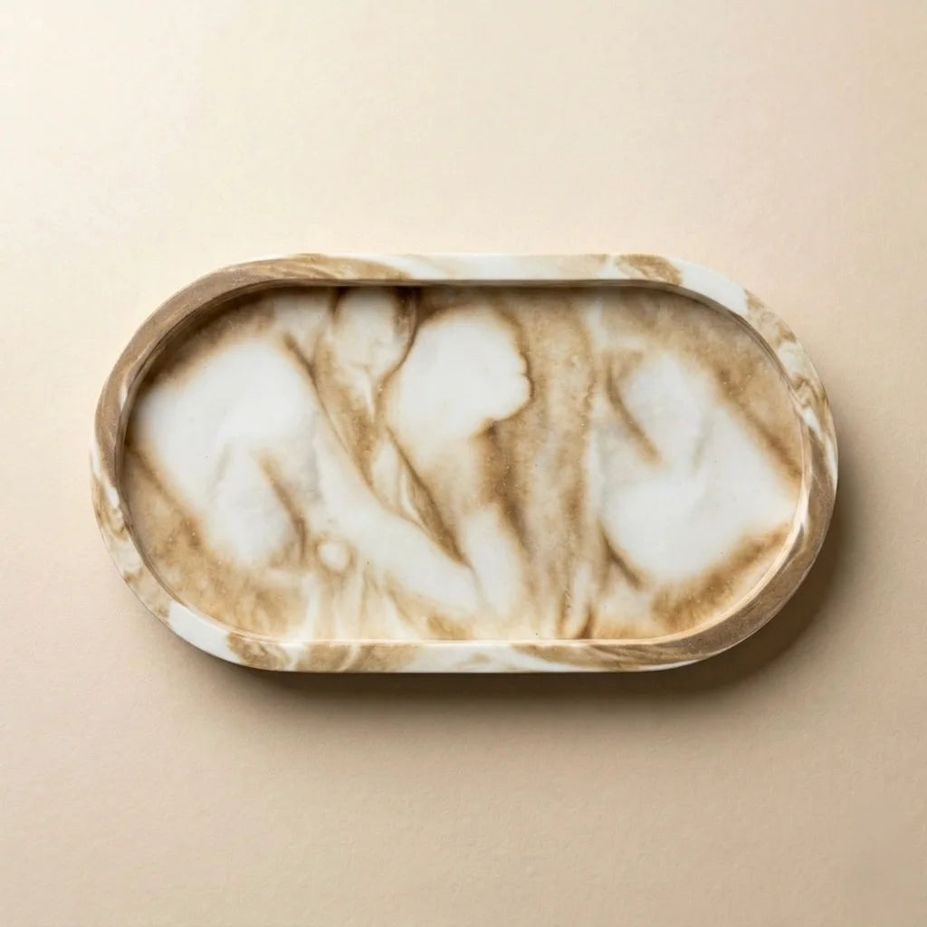 Oval marble-look decorative vanity tray in cream and beige stone pattern