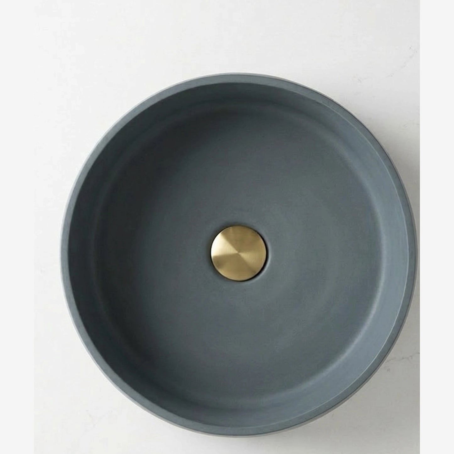 Top view of round concrete stone vessel sink in sage green color for modern bathroom vanity
