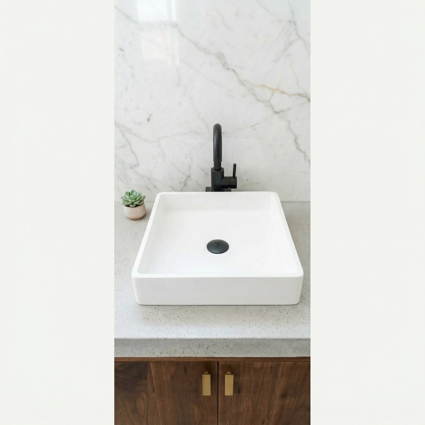 Matte white square vessel sink made from stone composite on modern bathroom countertop