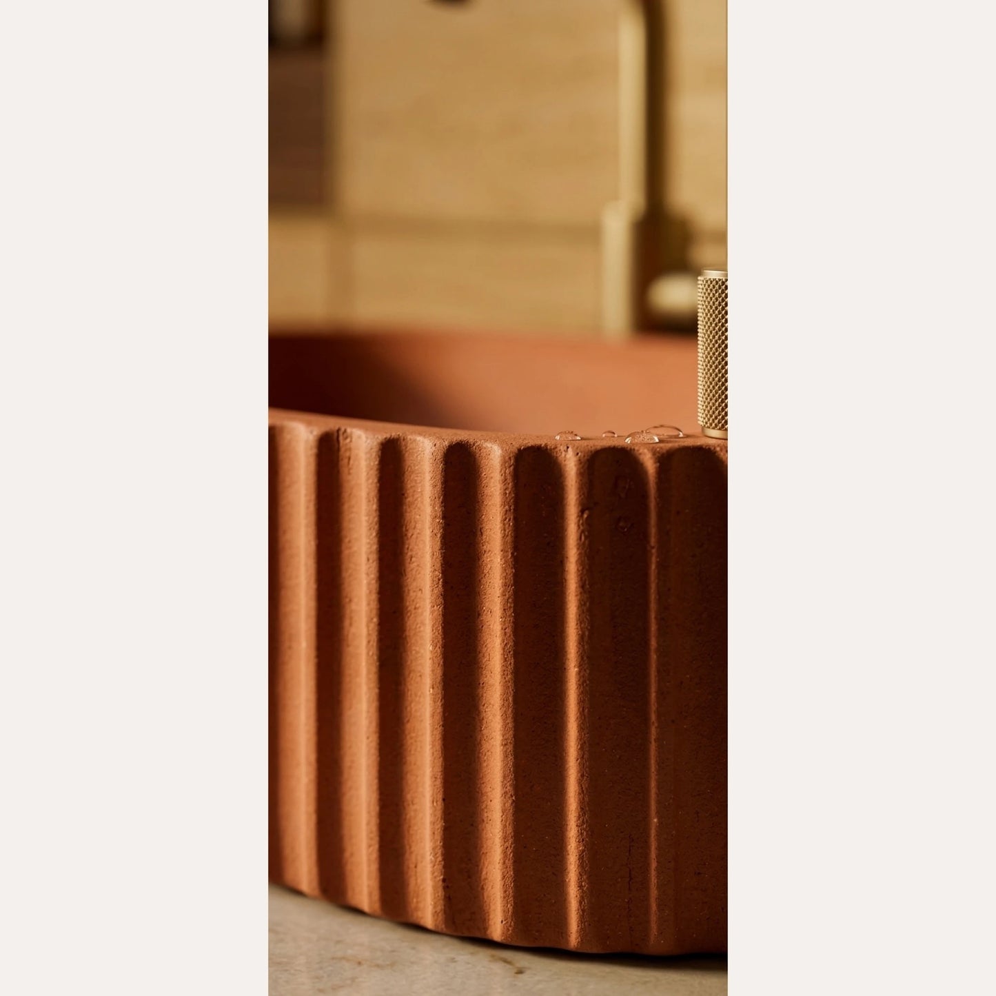 Close-up texture detail of terracotta fluted vessel sink