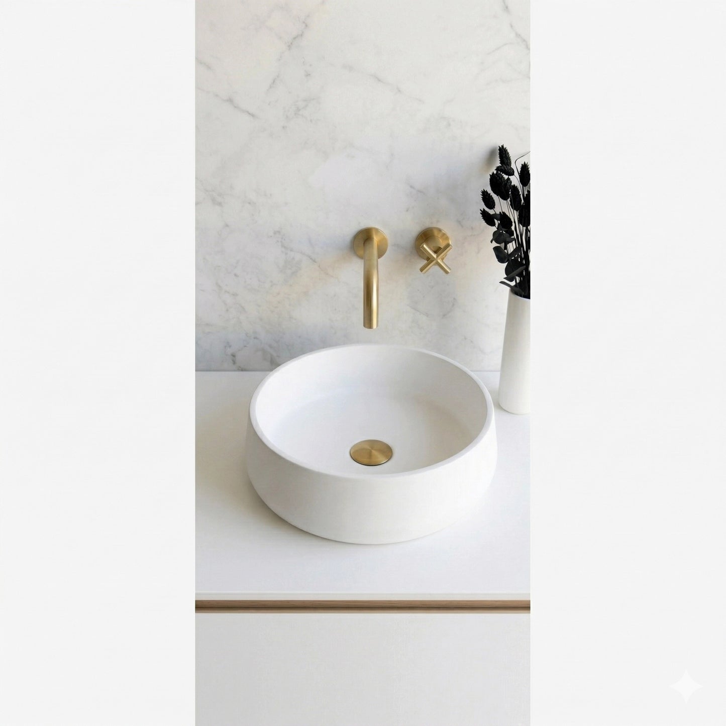 Round white concrete stone vessel sink on modern minimalist bathroom vanity with brass faucet